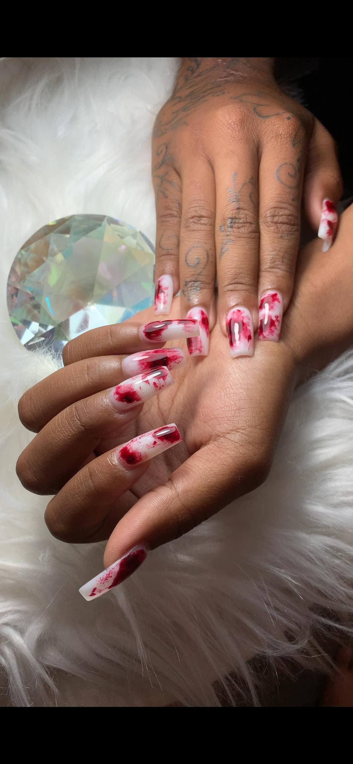 Long acrylic nails with red-and-white edgy art